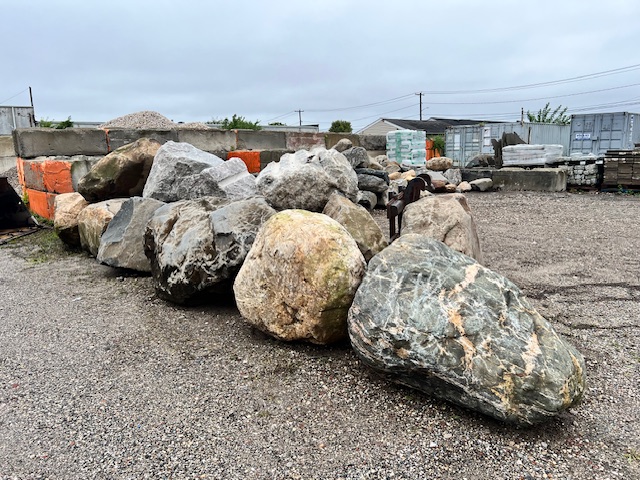 Row of large feature boulders staged at the yard