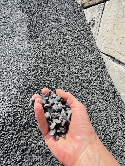 Handful of blue crushed stone gravel